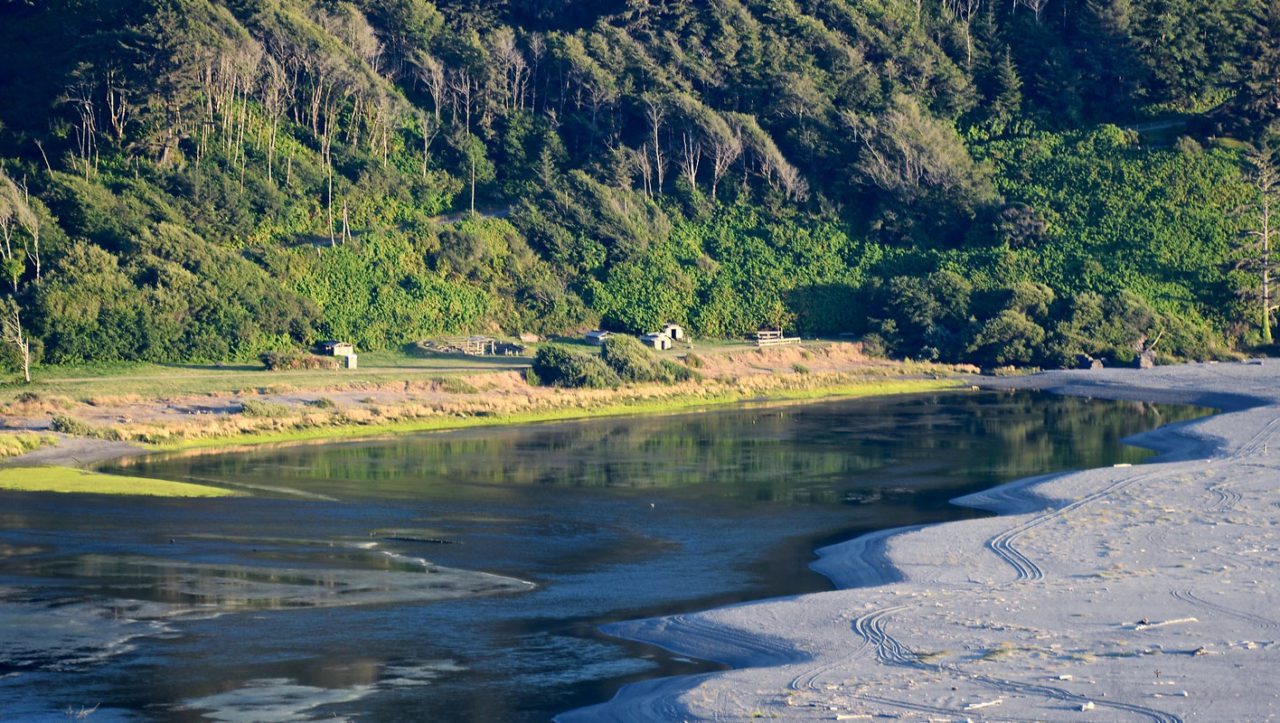 The estuary of the Klamath River with ceremonial buildings of the Yurok tribe. Photo by LInda Tanner/Wikimedia.